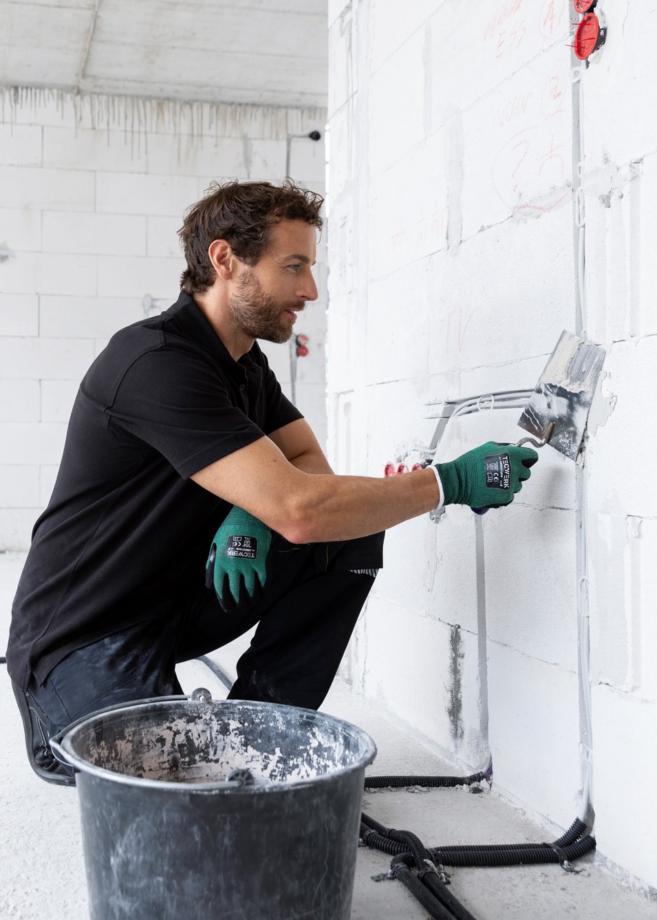 Craftsman plastering an interior wall